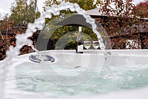 Two glasses of champagne near outdoor jacuzzi. Romantic getaway. Valentines background. Horizontal, shallow background