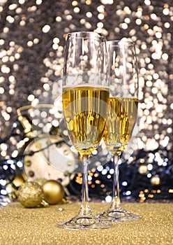 Two glasses of champagne at New Year`s Eve party golden shiny background stock images