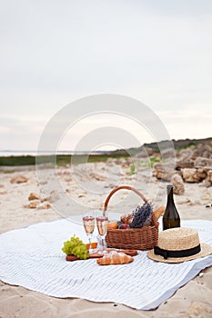 Two glasses of champagne. Picnic on the beach at sunset in the w