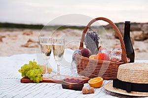 Two glasses of champagne. Picnic on the beach at sunset in the w