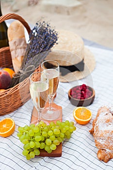 Two glasses of champagne. Picnic on the beach at sunset in the w