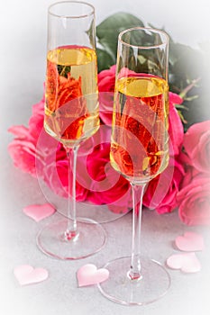 Two Glasses of Champagne and Pink Roses