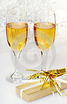 Two glasses of champagne with present and horn