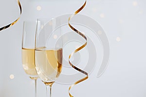 Two glasses of champagne with ribbons on a white background holiday in a festive atmosphere