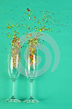 Two glasses champagne rosy spilled colored candies