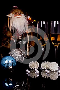 Two glasses champagne, Santa Claus and Christmas decoration