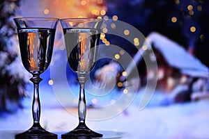 Two glasses with champagne sparkling wine on a winter evening background.
