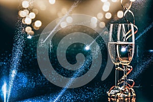 two glasses of champagne in the spotlight - new year celebration