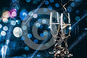 two glasses of champagne in the spotlight - new year celebration