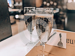 Two glasses of champagne on a table in a restaurant.Festive concept.