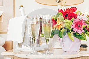 Two glasses of champagne in the upscale hotel room. Dating, romance, honeymoon, valentine, getaway concepts