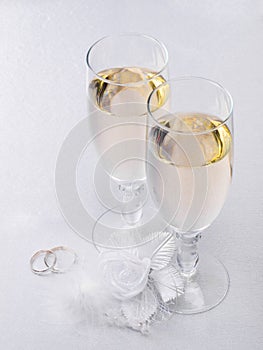 Two glasses with champagne and wedding decoration