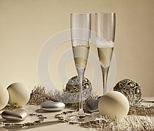 Two glasses with champange, gift boxes and christmas decorations