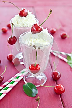 Two glasses with cherry milkshake