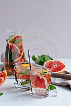Two glasses of Cocktail grapefruit with fruits.