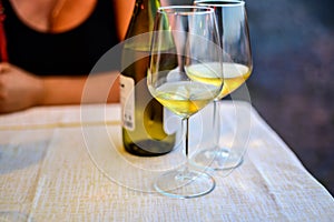 Two glasses of cold dry white wine served outdoor in cafe at night in Italy