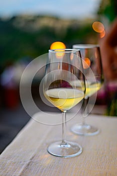 Two glasses of cold dry white wine served outdoor in cafe at night in Italy