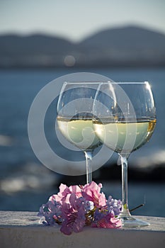 Two glasses with cold white wine served outside on terrace with