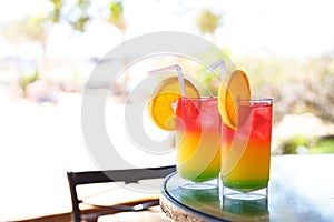 Two glasses with colorful cocktail