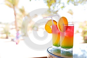 Two glasses with colorful cocktail