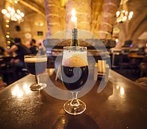 Two glasses of craft beer in a typical belgian pub