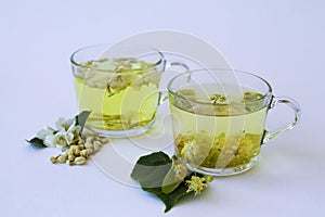 Two glasses cups with herbal hot jasmine tea and Tea from Linden flowers