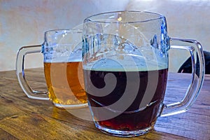 The two glasses of czech beer on a wooden barrel table