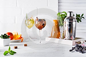 Two glasses with drink and Cocktail shaker for preparing a summer cocktail with a place for your subject and text