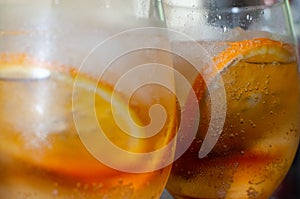 Two glasses. Two drinks with orange ice tea. Oranges slices. Close up 2 photo