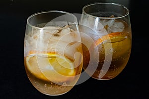 Two glasses. Two drinks with orange ice tea. Oranges slices 3 photo