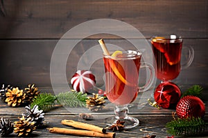 Two glasses with festive mulled wine, orange and cinnamon. Christmas and New Year atmosphere. Warm, cozy photo