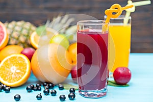 Two glasses of fresh juice with tropical fruit