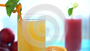Two glasses of fresh orange and grapefruit juice