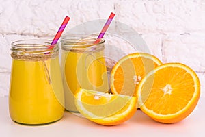 Two glasses of fresh orange juice on a white background. Close-up.