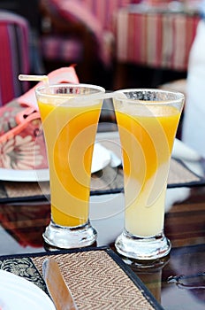Two glasses of freshly squeezed juice