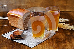 Two glasses of homemade bread kvass with black rye bread