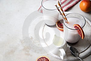 Two glasses of Italian soda with blood orange syrup, milk and ice