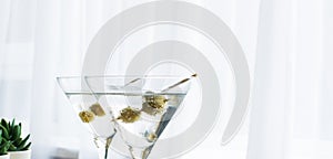 Two glasses of Martini with olive on white backgroundwith copy space