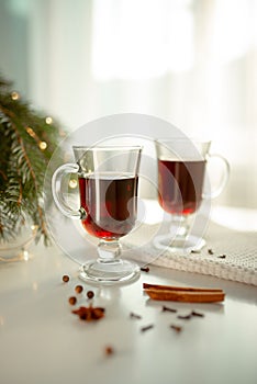 Two glasses of mulled wine on the table with spices