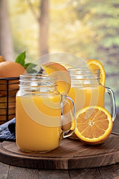 Two glasses of orange juice with orange slices