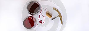 Two glasses of pink red wine, bottle opener and corkscrew  on white background with Traces of wine. Free copy space.