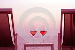 Two glasses of red wine on the background of the sea.