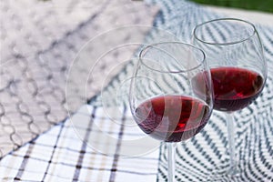 Two glasses with red wine on a beautiful tablecloth. Top view of alcoholic drink