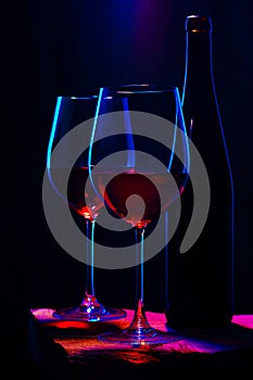 Two glasses of red wine with bottle