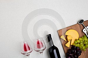 Two glasses of red wine, cheese and grapes. Top view