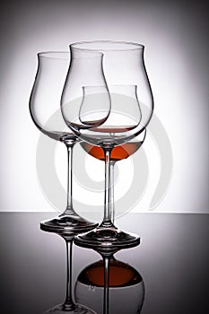 Two glasses with red wine, creating the illusion of four