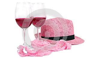 Two glasses of red wine near pink panties