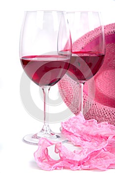 Two glasses of red wine near pink panties photo