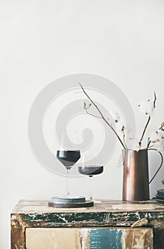 Two glasses of red wine over rustic countertop, copy space