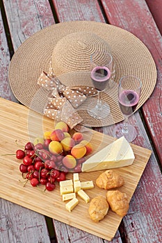 Two glasses of red wine, served outdoor with fruits